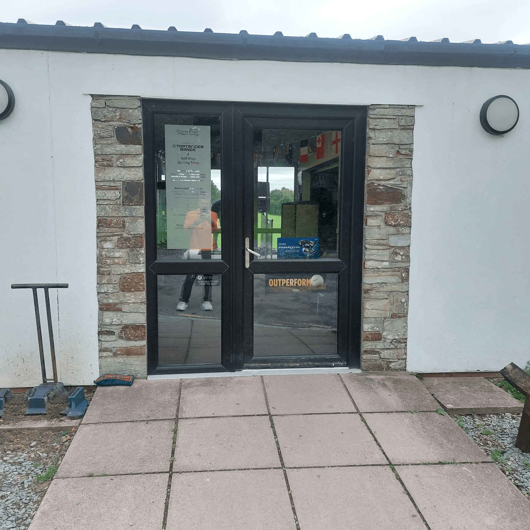 Dark composite door fitted to stone-clad building